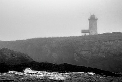 Libby Island Lighthouse on Rocky Hilltop in Dense Fog -BW